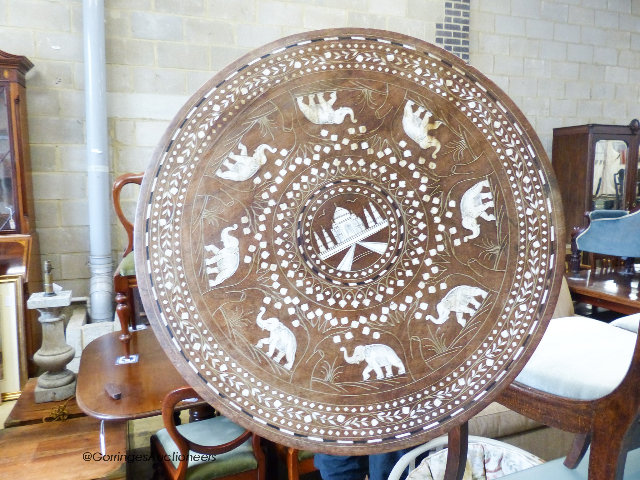 An Indian circular inlaid hardwood occasional table. D-50, H-46cm.